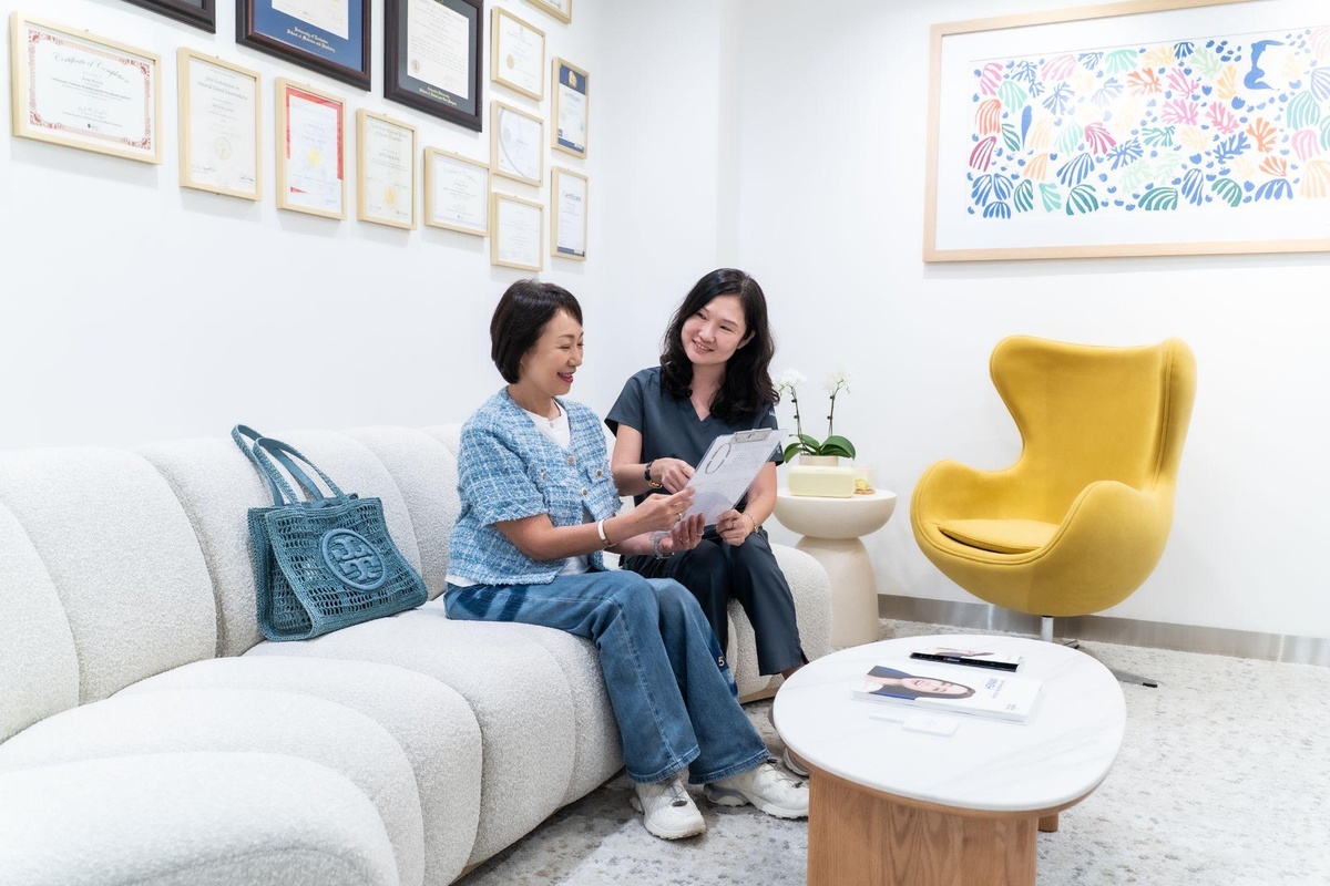 Dentist reviewing a 3D scan with a patient during a dental implant consultation in Singapore