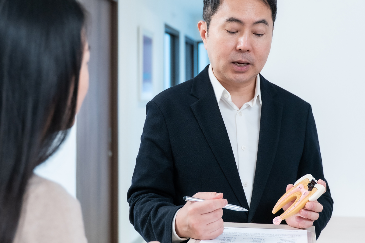 Dentist explaining veneer suitability to a patient in Singapore